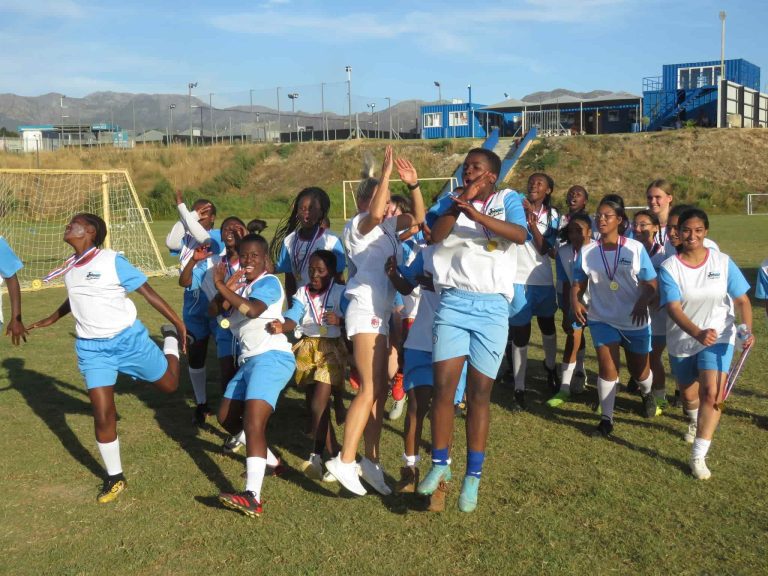 The participants of the Young Bafana Girls Camp by Julia Simic celebreating on the pitch of the YB Arena.