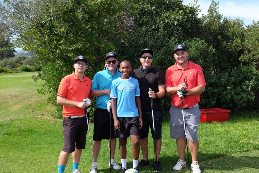 Five golfers in a group photo during Young Bafana golf day.