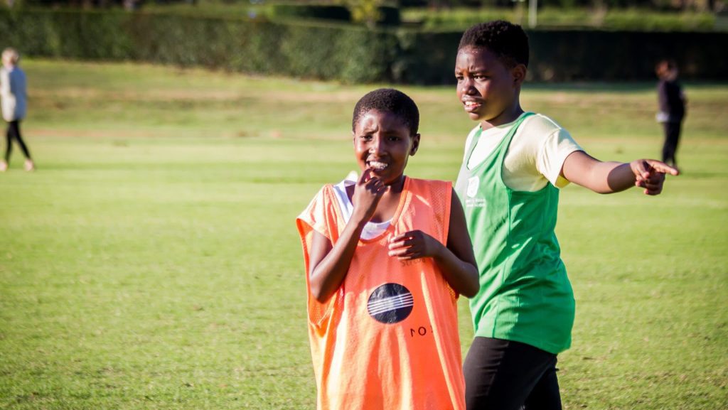 Two players of the Young Bafana Soccer Academy looking concentrated during training.